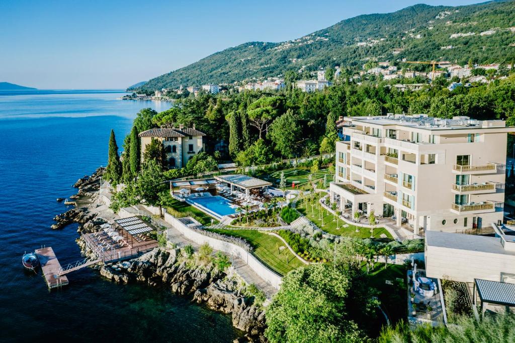 an aerial view of a building on a cliff next to the water at Ikador Luxury Boutique Hotel & Spa in Opatija