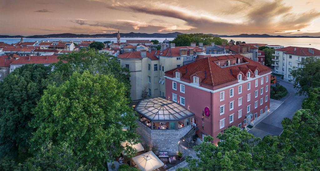 an aerial view of a city with a pink building at Bastion Heritage Hotel - Relais & Châteaux in Zadar