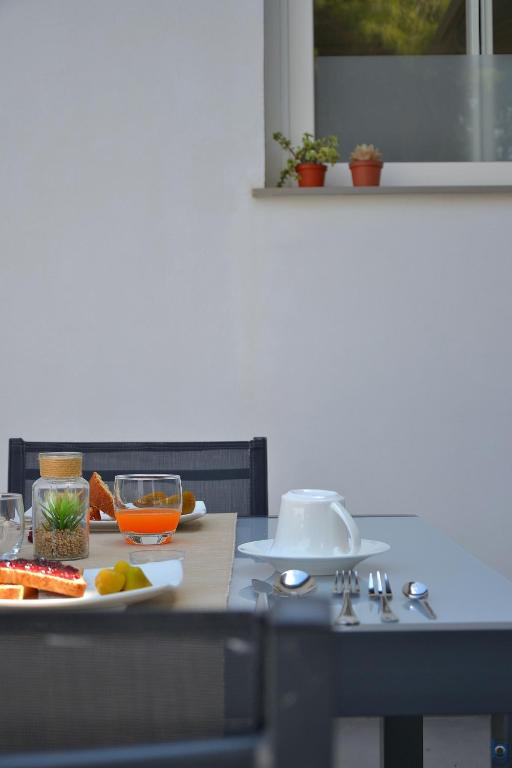a table with a plate of food on it at B&b Mondello Resort in Palermo