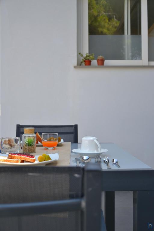 a kitchen with a table with a plate of food on it at B&b Mondello Resort in Palermo