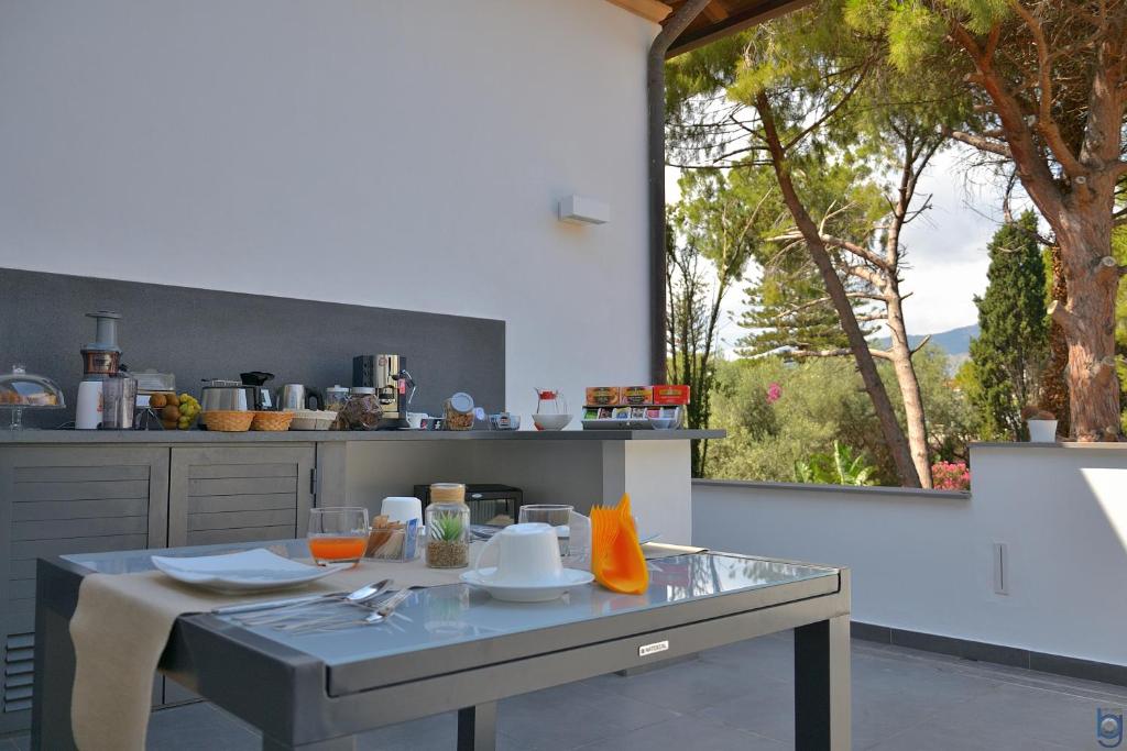 a kitchen with a counter with a table with a window at B&b Mondello Resort in Palermo