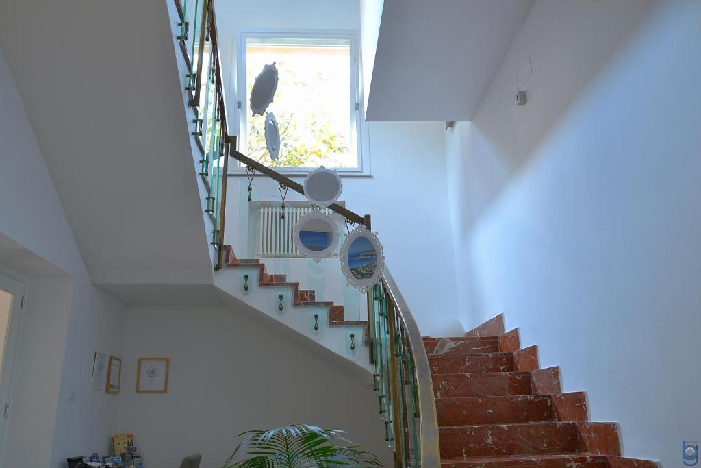 a staircase in a house with a bird sitting on the window at B&b Mondello Resort in Palermo