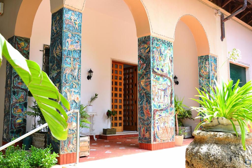 an entry to a building with colorful tiles at B&b Mondello Resort in Palermo