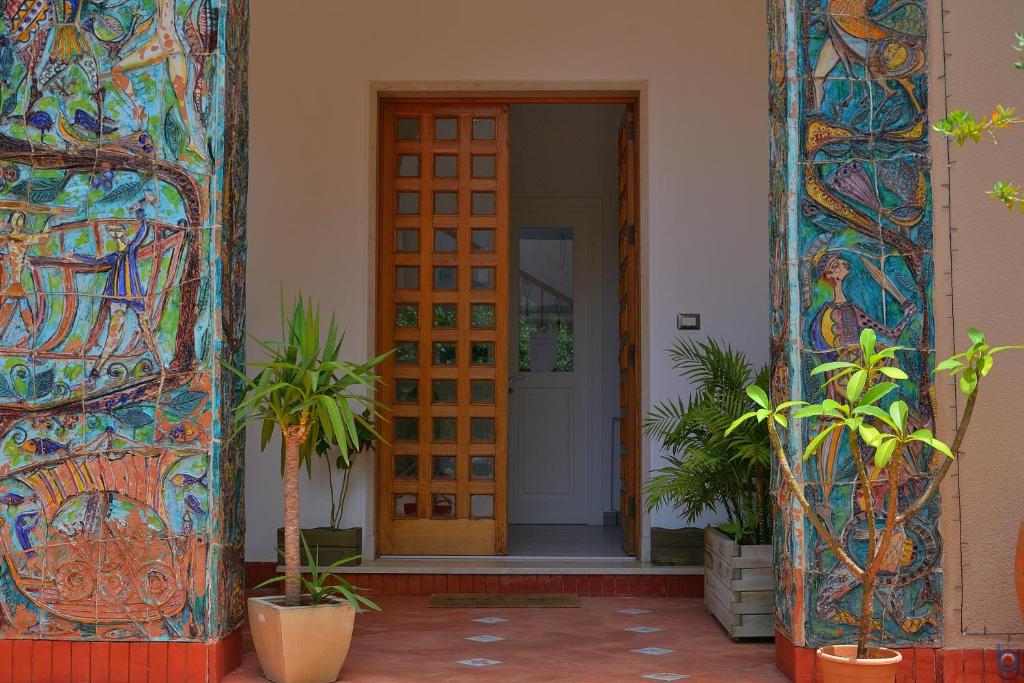 an entrance to a building with a door and plants at B&b Mondello Resort in Palermo