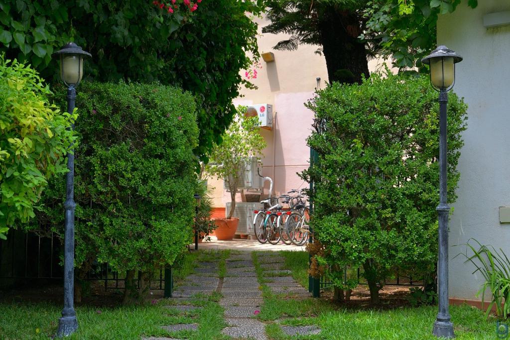 a garden with two street lights next to a building at B&b Mondello Resort in Palermo