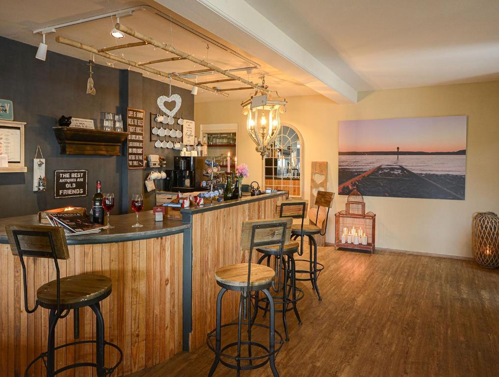 a bar in a restaurant with stools in a room at ABACCO Ferienwohnungen in Überlingen