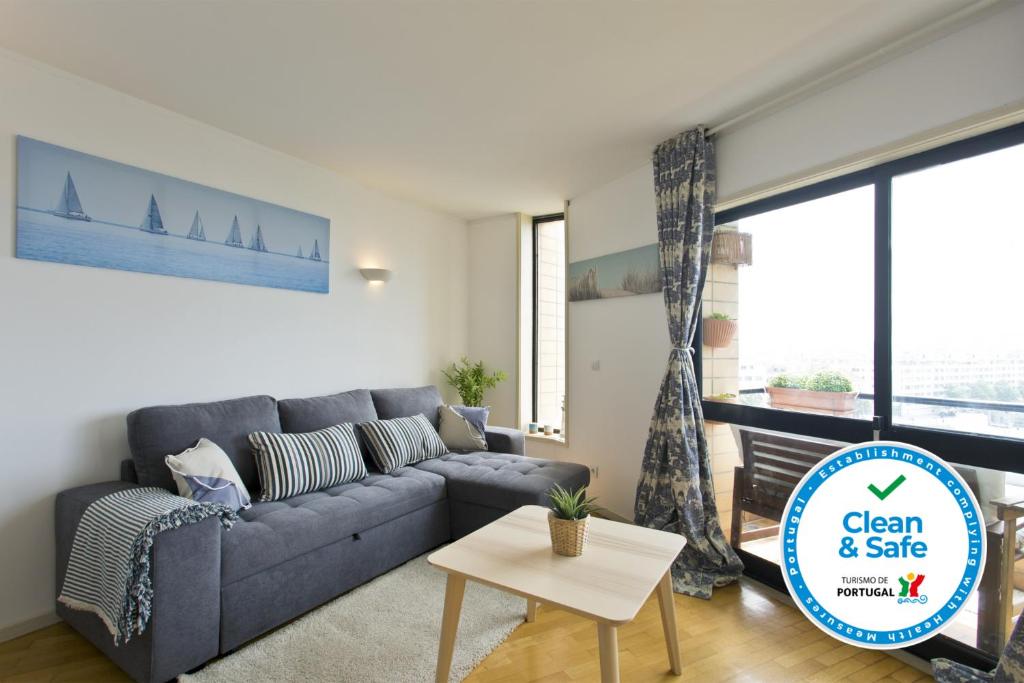 a living room with a couch and a table at Amazing Comfy Flat with Balcony by Host Wise in Matosinhos