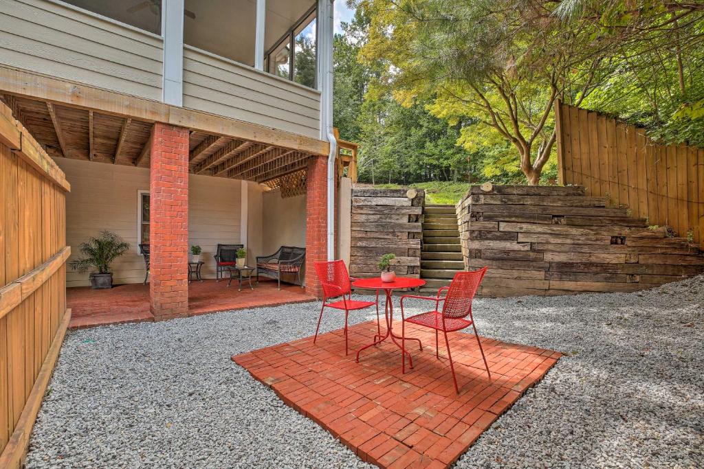 a patio with red chairs and a table on a patio at Quiet Neighborhood Retreat - 13 Mi to Dtwn Atlanta in Mableton