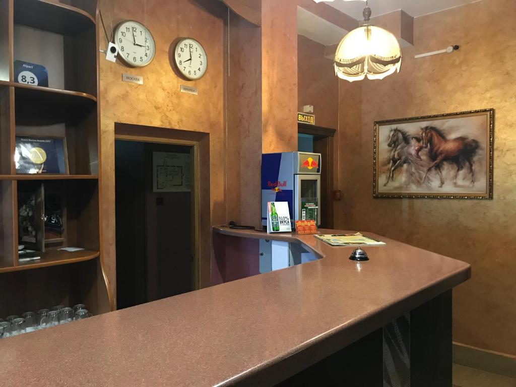 a room with clocks on the walls and a counter at Alpari in Irkutsk