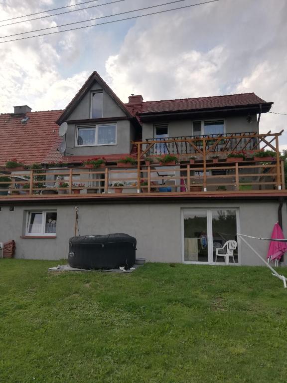 a house with a deck on top of it at Apartament Bukowy in Kłodzko
