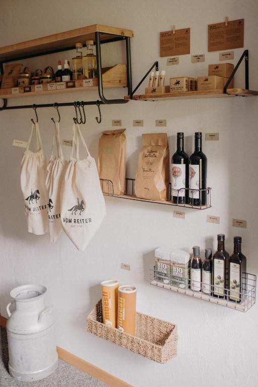 a shelf with bottles of wine and bags on a wall at VOM REITER, Ferienwohnung am Bauernhof mit Bergblick und privater Infrarotkabine, Inklusive Sommercard in Schladming
