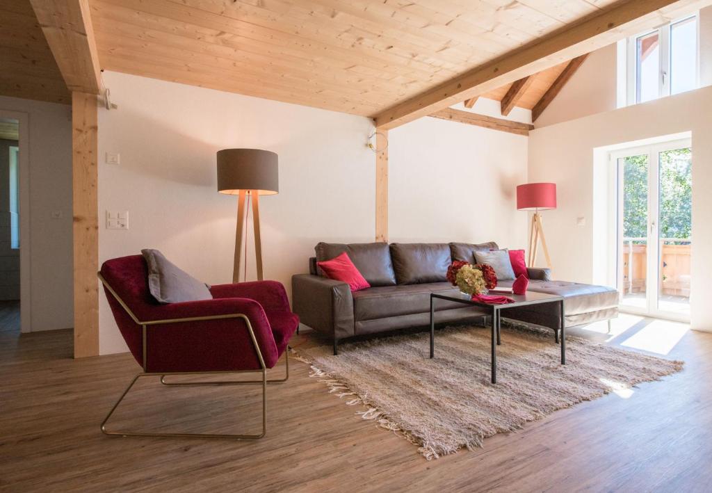 a living room with a couch and a table at Le Manoir Penthouse in Wengen