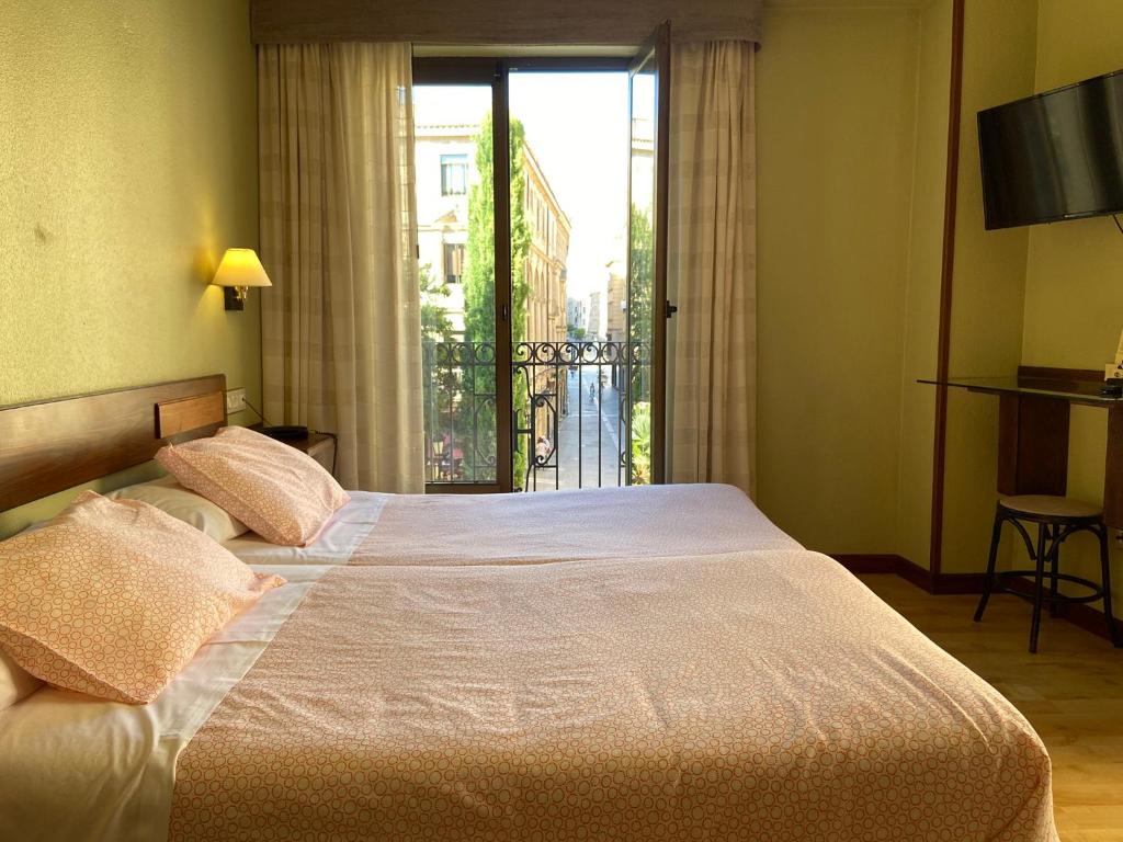Postel nebo postele na pokoji v ubytování Hostal Concejo