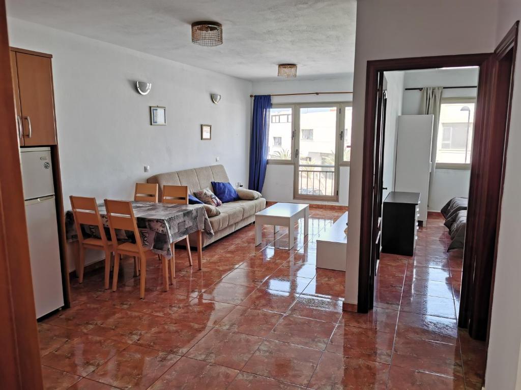 a living room with a couch and a table at Cotillo Faro in El Cotillo