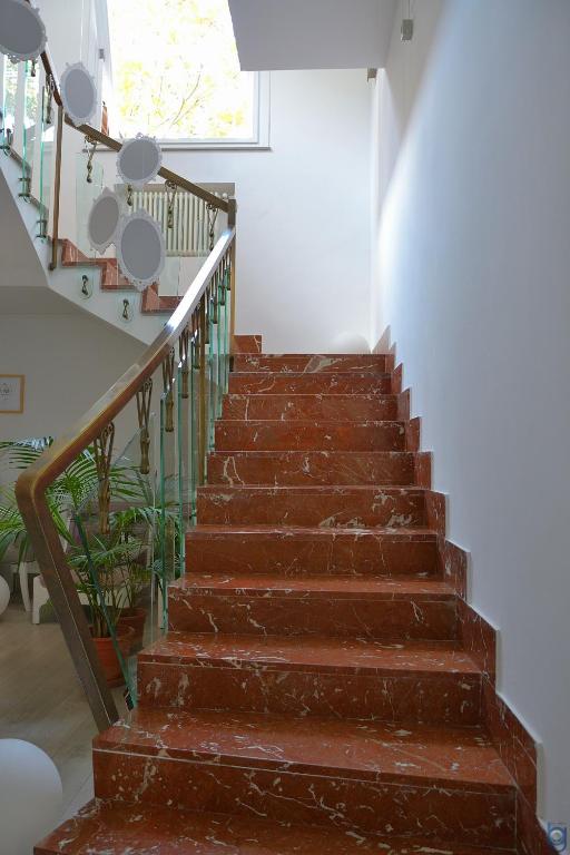 a staircase in a house with brown steps and a window at B&b Mondello Resort in Palermo