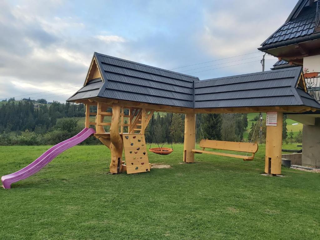 a playground with a gazebo and a slide at Willa Za Potokiem in Bukowina Tatrzańska