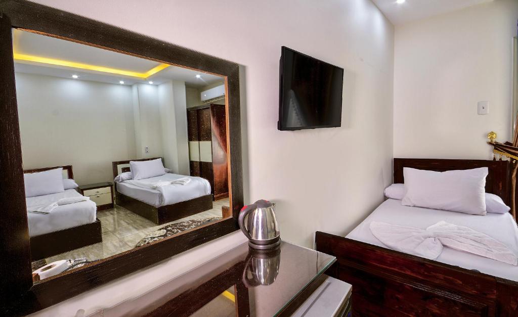 A bed or beds in a room at TuT Pyramids View