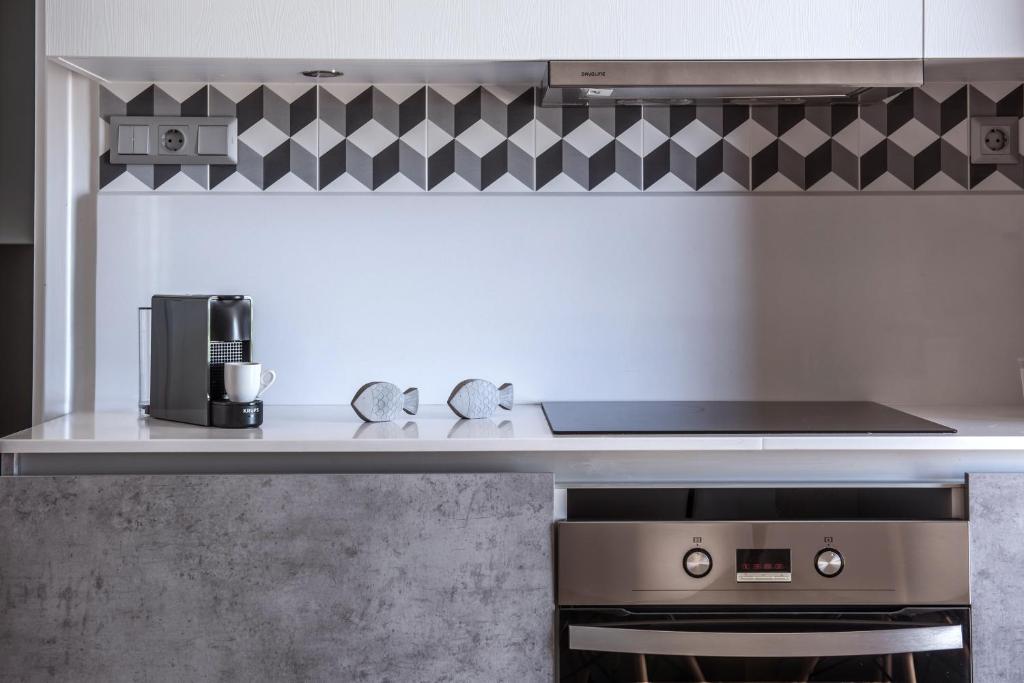 a kitchen with a stove and a counter top at Skajado Holiday Apartments in Stalís