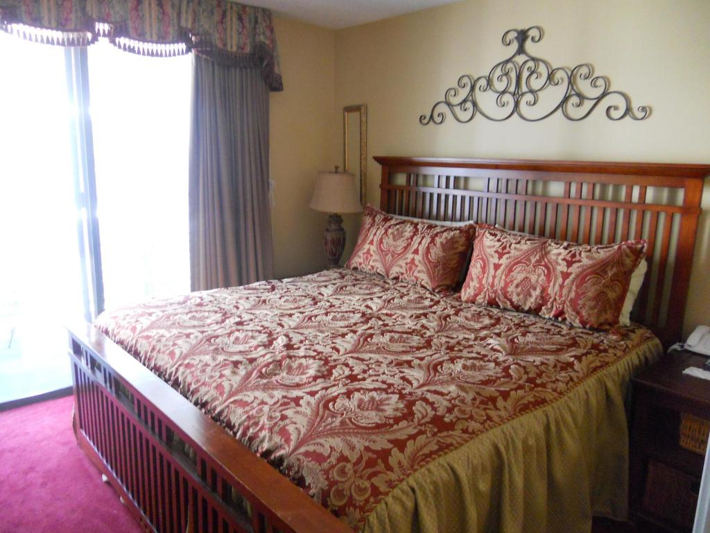 a bedroom with a large bed with red pillows at Oak Square 201 in Gatlinburg