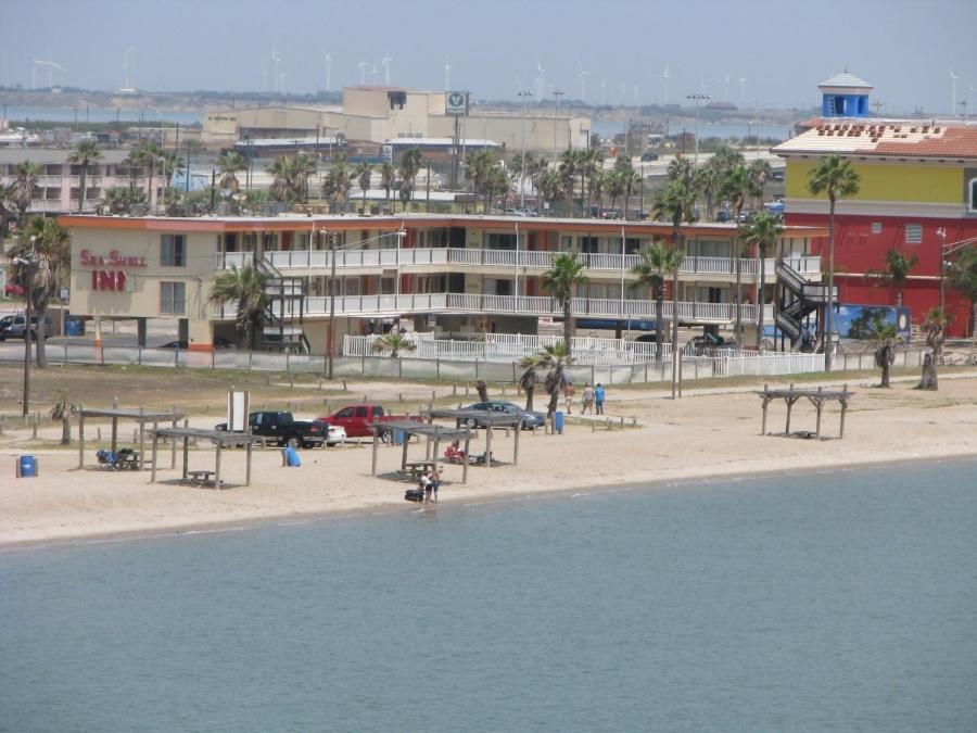 a view of a beach with a building in the background at Sea Shell Inn on the beach in Corpus Christi