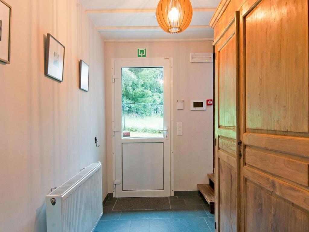 a hallway with a door and a window at Holiday Home between Spa and Eifel Nature Park in Xhoffraix