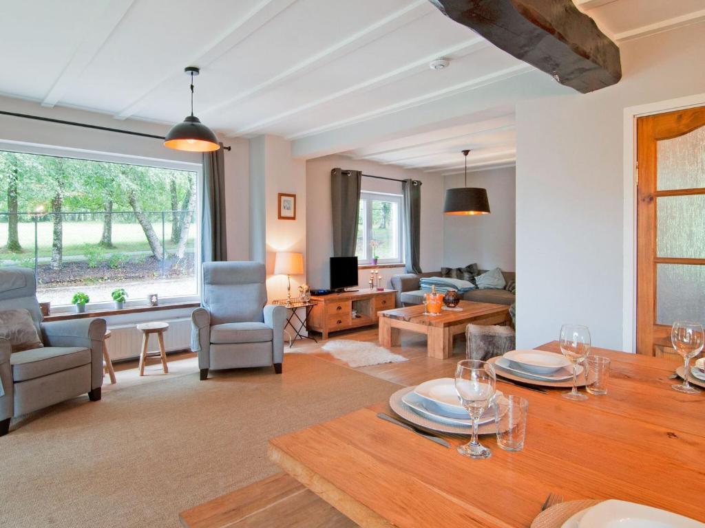 a living room with a table and a couch at Holiday Home between Spa and Eifel Nature Park in Xhoffraix
