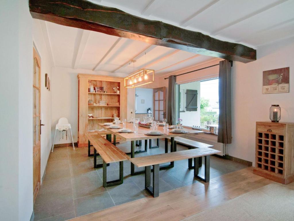 a dining room with a table and a large window at Holiday Home between Spa and Eifel Nature Park in Xhoffraix