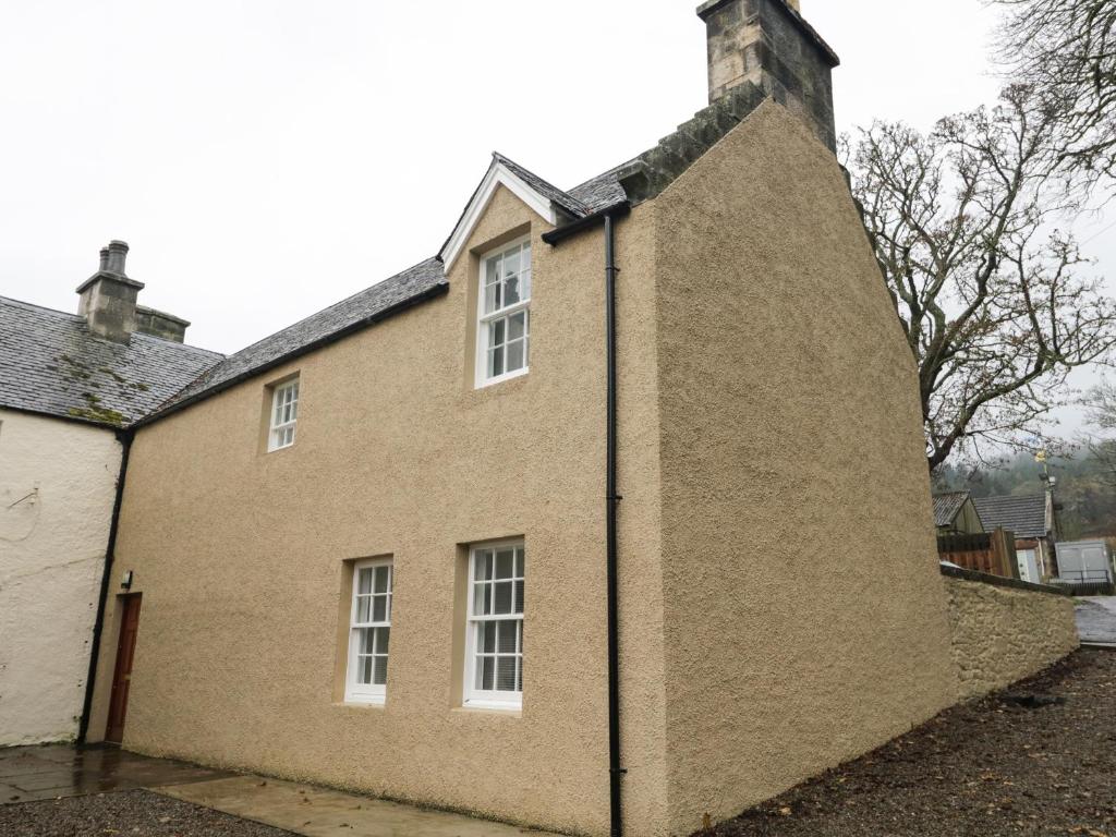 a large brick building with white windows on it at Tartan in Golspie