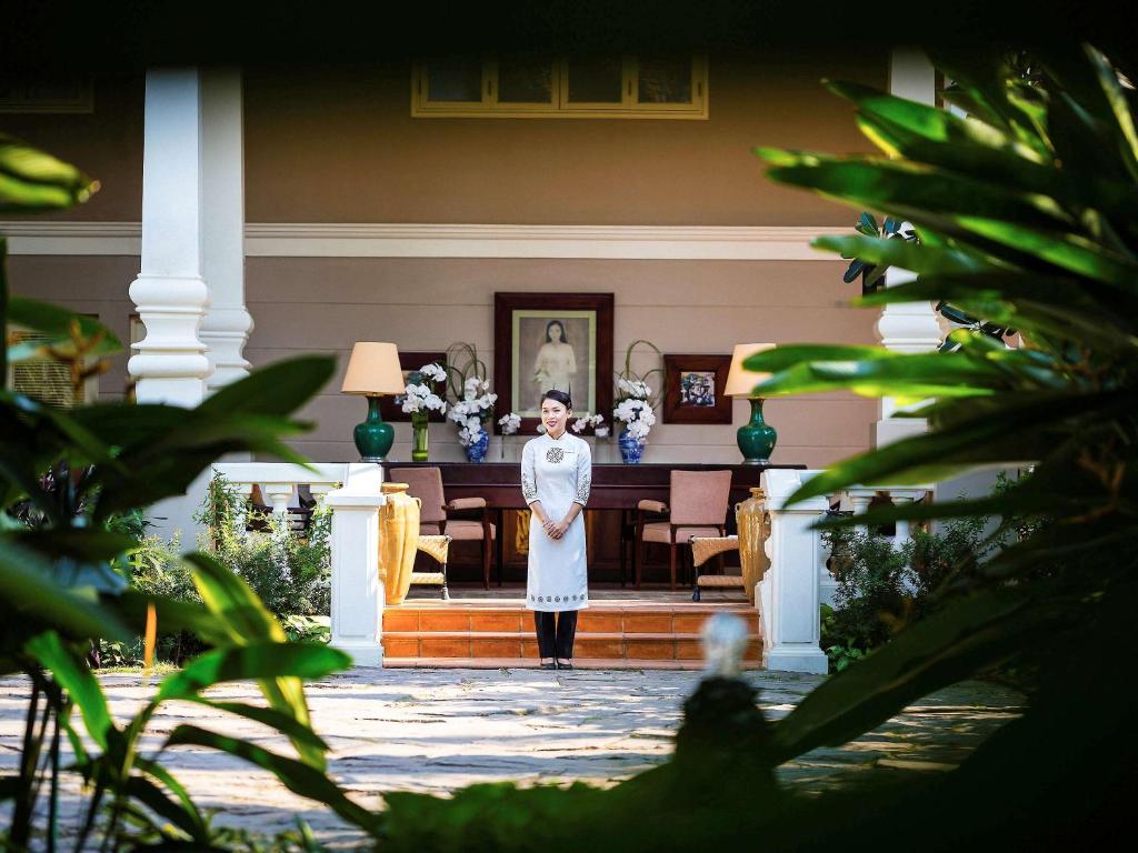 a woman standing in the middle of a room at La Veranda Resort Phu Quoc - MGallery in Phu Quoc