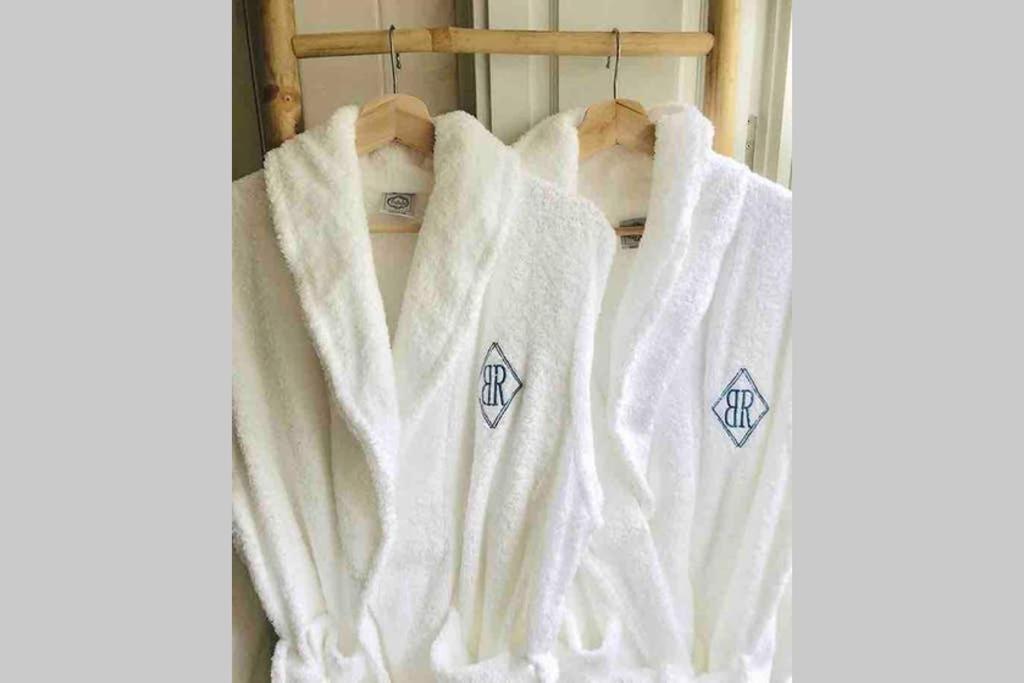 a group of white towels hanging on a rack at BOUTIQUE Rentals- ATTICO Luxury Design-Ocean views in Porto