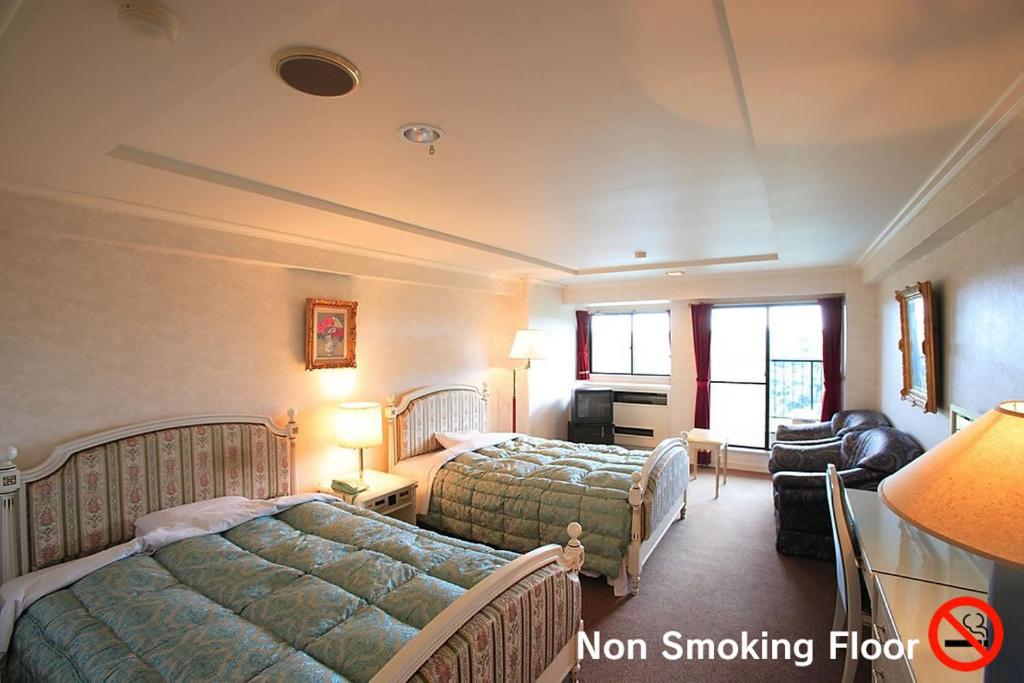 Postel nebo postele na pokoji v ubytování Hotel Green Hill Otaki