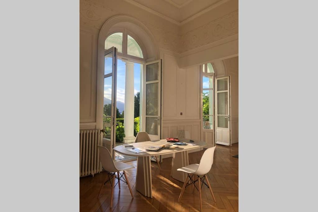 a dining room with a table and chairs at Magnifique Appartement dans palace Belle Époque in Aix-les-Bains