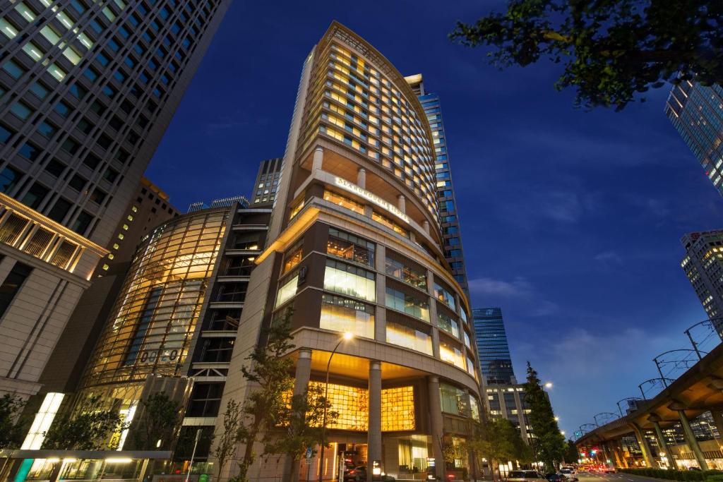 a tall building in a city at night at Marunouchi Hotel in Tokyo