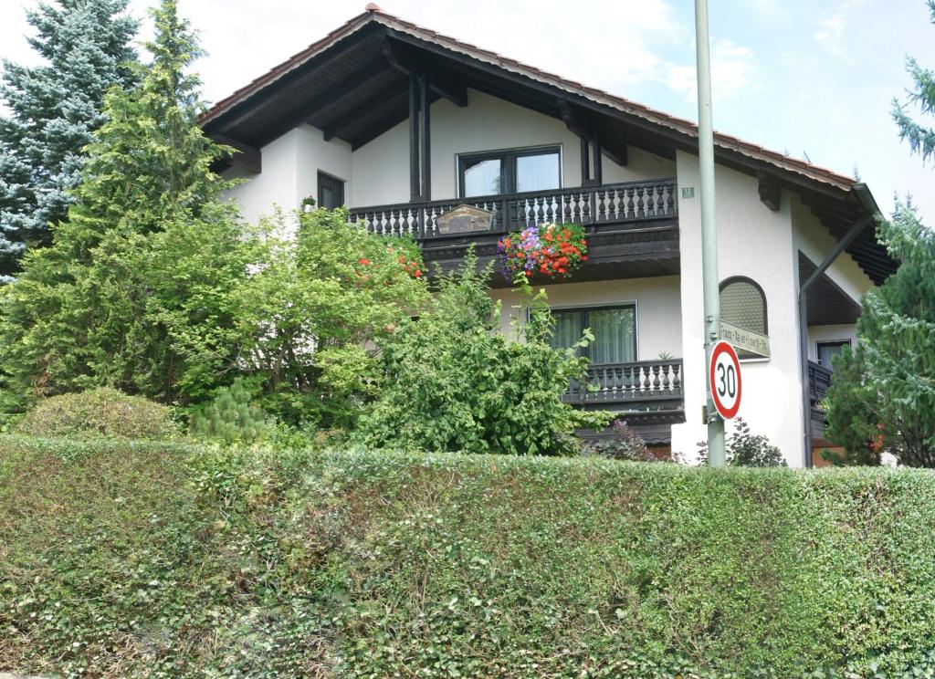 a house with a balcony on top of a hedge at wohnung oben Steiger in Bad Birnbach