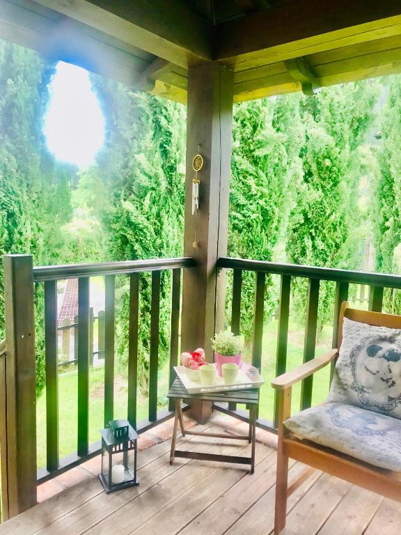 a porch with a table and a chair on a balcony at Casa Mayor in Gordexola