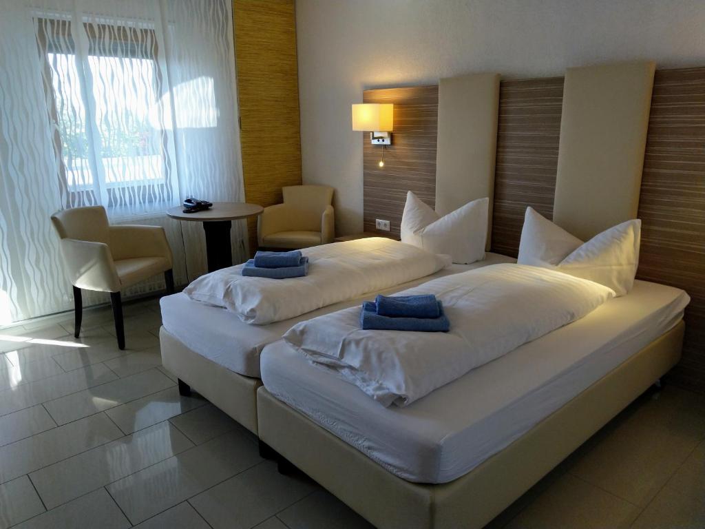 a large white bed in a hotel room at sachsenhotel in Torgau