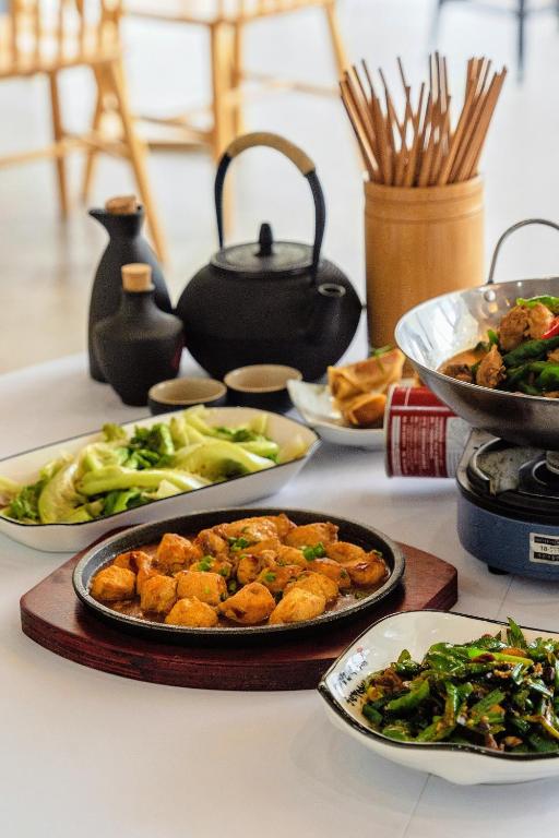 a table with plates of food on a table at Whispering Mountains Boutique Hotel in Zhangjiajie