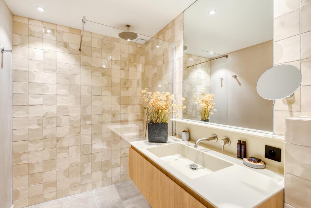 a bathroom with a sink and a mirror at Domaine Santa Giulia Palace in Porto-Vecchio