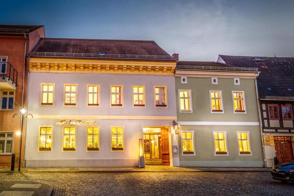 un gran edificio blanco con luces encendidas en Ferienwohnung Zum Deutschen Hause, en Lübbenau