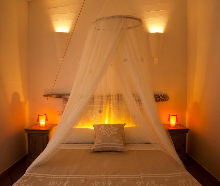 A bed or beds in a room at AgriRistoChic - Resort Li Espi