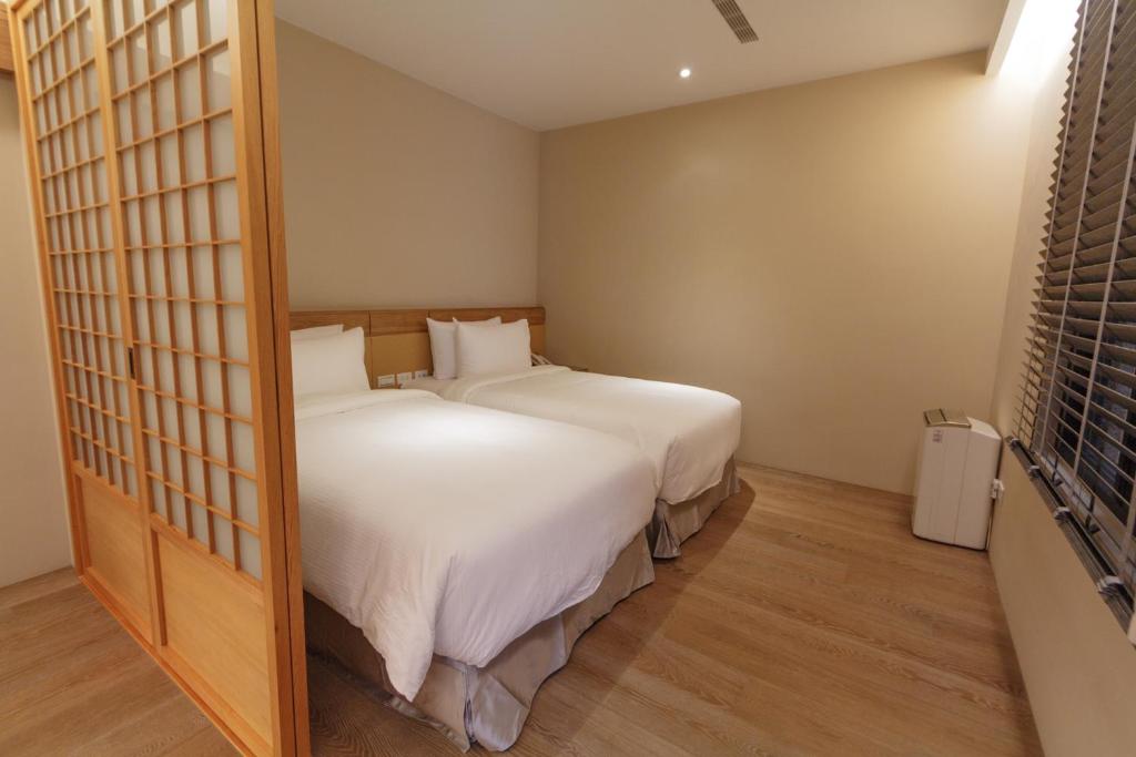 Postel nebo postele na pokoji v ubytování 金漫會館-金瓜石九份景觀民宿-Jien Mount Villas