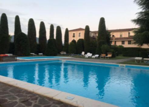 a large blue swimming pool in front of a building at WHITE HOUSE in Brescia
