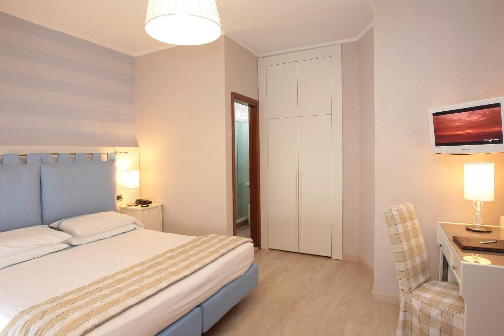 Postel nebo postele na pokoji v ubytování Hotel Rivamare