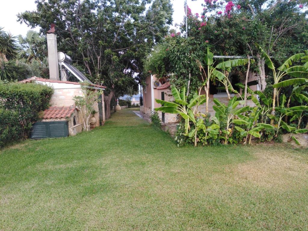 un patio con una casa y algunas plantas en Golden sea villa (30 meters from the sea), en Kalamata