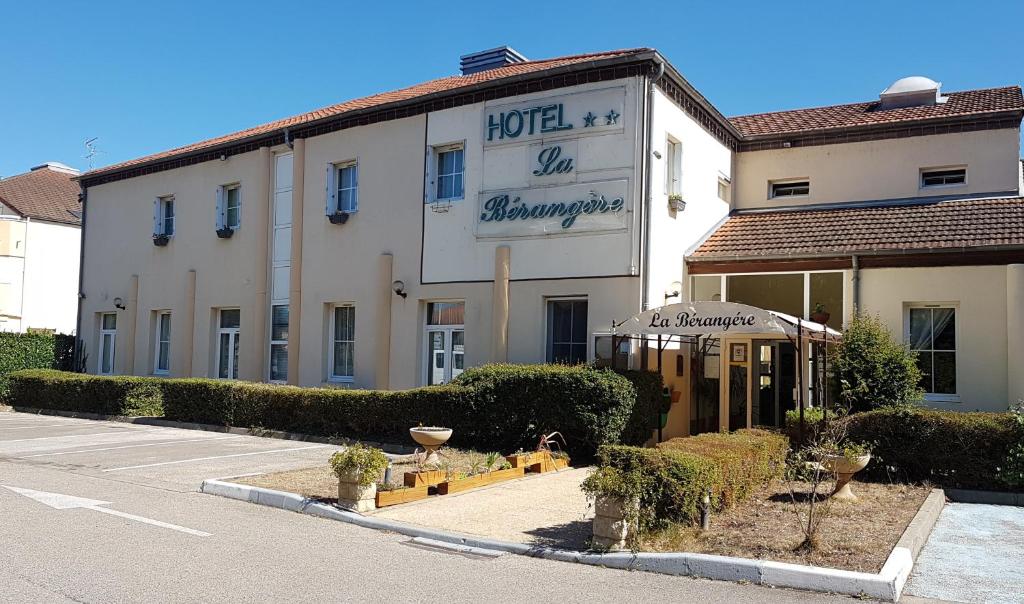 a hotel with a sign on the side of a building at Hôtel La Bérangère in Pérouges