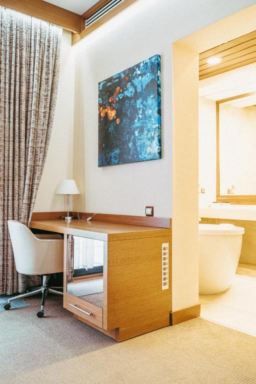 an office with a desk and a chair in a room at Arfa Park-Hotel in Adler