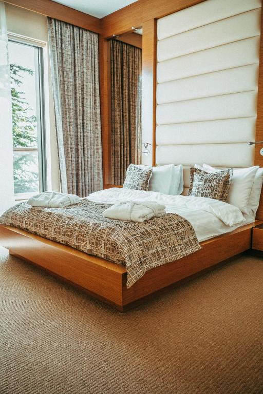 a bedroom with a large bed in front of a window at Arfa Park-Hotel in Adler