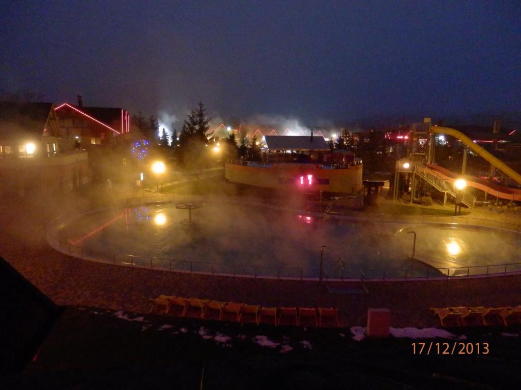 a park at night with a roller coaster at Free Apartman Besenova in Bešeňová