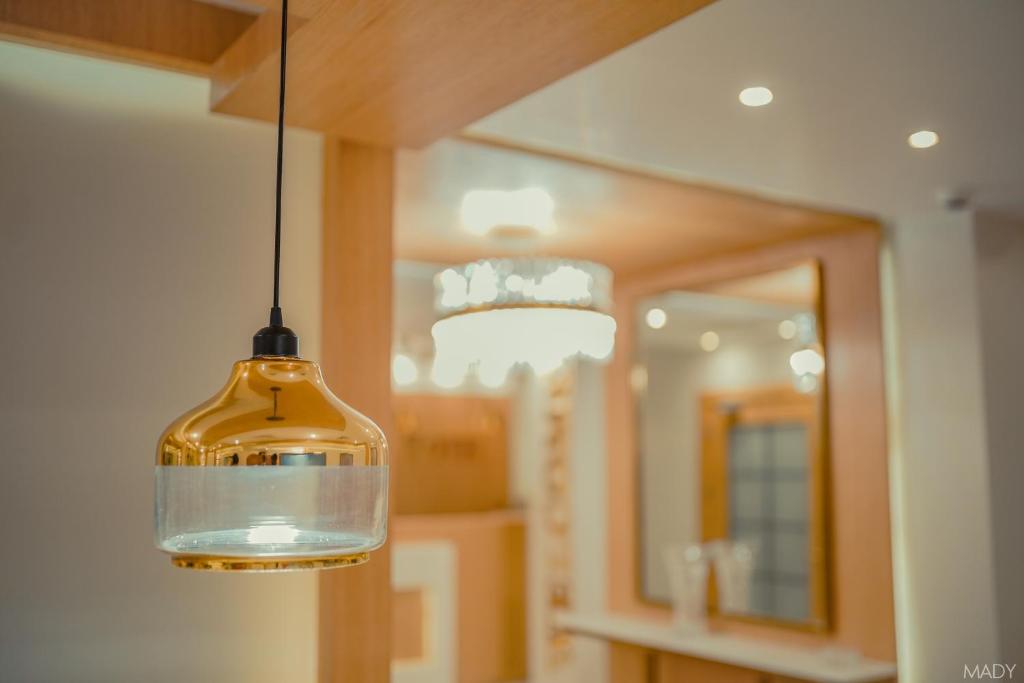 a glass pendant light hanging in a bathroom at Miramar Boutique Hotel in Alexandria