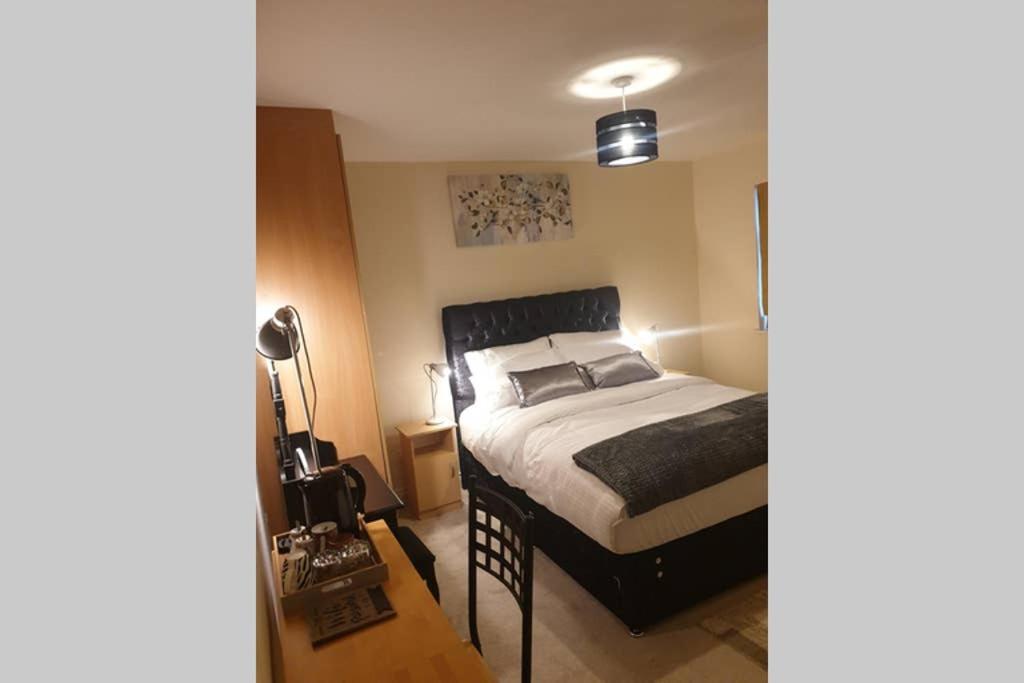 a bedroom with a bed with a black bed frame at private-ensuite-room Limerick city stay in Limerick